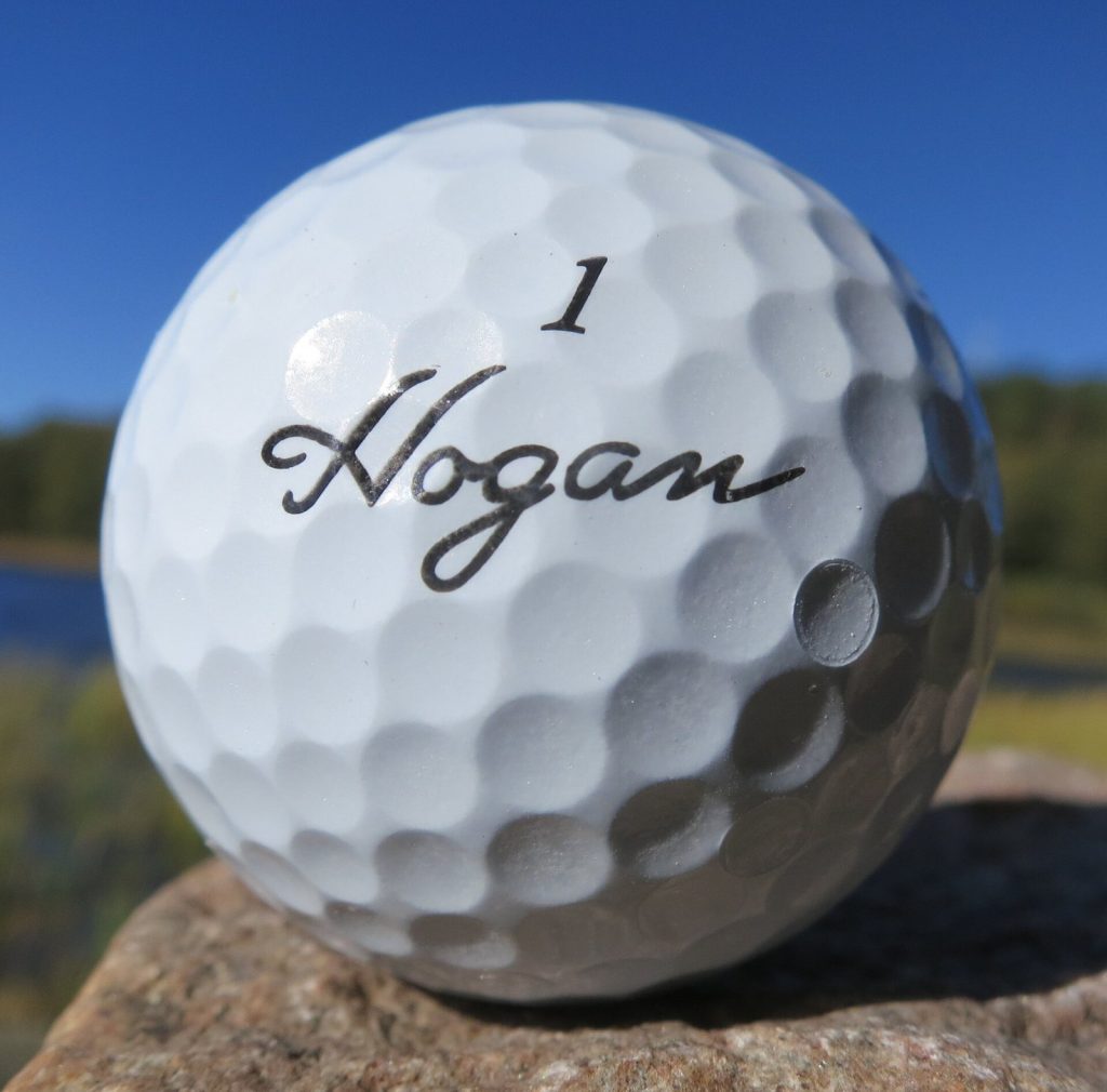 Close-up of a Ben Hogan Apex Tour four-piece golf ball with urethane cover